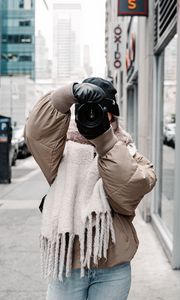 Preview wallpaper girl, photographer, camera, city, buildings