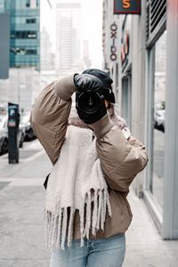 Preview wallpaper girl, photographer, camera, city, buildings