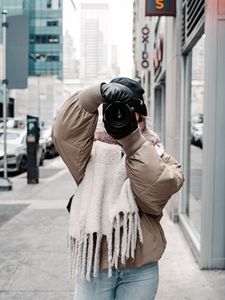 Preview wallpaper girl, photographer, camera, city, buildings