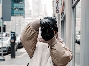 Preview wallpaper girl, photographer, camera, city, buildings