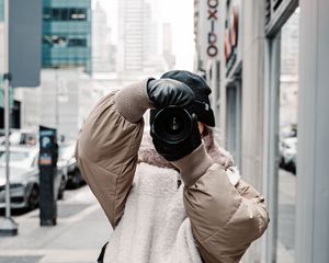 Preview wallpaper girl, photographer, camera, city, buildings