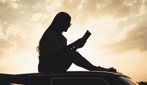 Preview wallpaper girl, reading, books, silhouette, car