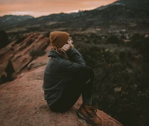 Preview wallpaper girl, rock, cliff, mountains, landscape