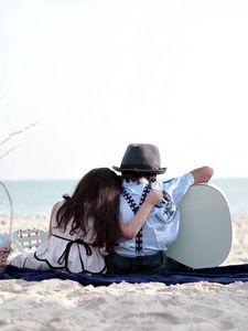 Preview wallpaper girl, sand, trash, grass, couple, date