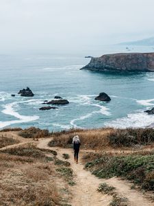 Preview wallpaper girl, sea, walk, travel, rocks, stones, shore