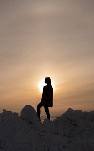 Preview wallpaper girl, silhouette, alone, stones, sunset, sun, dark