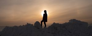 Preview wallpaper girl, silhouette, alone, stones, sunset, sun, dark