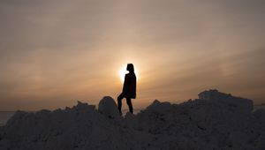 Preview wallpaper girl, silhouette, alone, stones, sunset, sun, dark