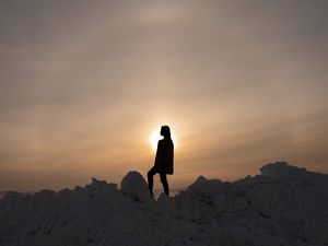 Preview wallpaper girl, silhouette, alone, stones, sunset, sun, dark