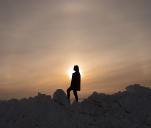 Preview wallpaper girl, silhouette, alone, stones, sunset, sun, dark