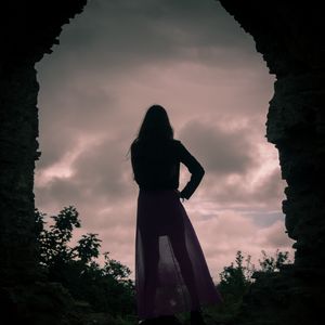 Preview wallpaper girl, silhouette, cave, twilight, dark