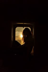 Preview wallpaper girl, silhouette, window, sunset, sun, light, dark