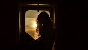 Preview wallpaper girl, silhouette, window, sunset, sun, light, dark