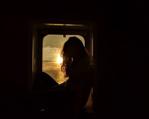 Preview wallpaper girl, silhouette, window, sunset, sun, light, dark