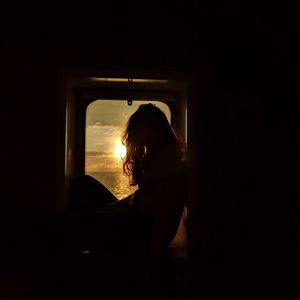 Preview wallpaper girl, silhouette, window, sunset, sun, light, dark