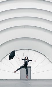 Preview wallpaper girl, umbrella, building, minimalism, jump