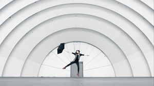 Preview wallpaper girl, umbrella, building, minimalism, jump