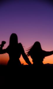 Preview wallpaper girls, silhouettes, dance, twilight, dark