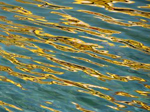 Preview wallpaper glare, water, ripples, golden, waves