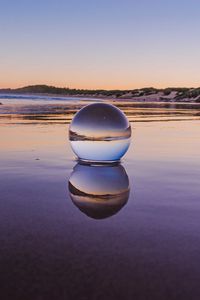 Preview wallpaper glass ball, ball, lake, reflection, sunset