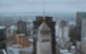 Preview wallpaper glass, drops, city, buildings, wet, macro