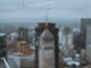 Preview wallpaper glass, drops, city, buildings, wet, macro