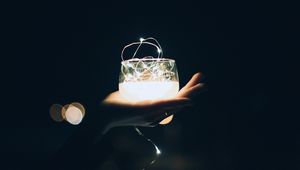 Preview wallpaper glass, garland, hand, light, dark, darkness