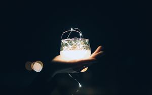 Preview wallpaper glass, garland, hand, light, dark, darkness