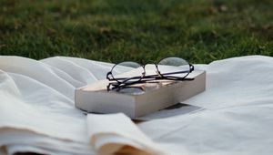 Preview wallpaper glasses, book, grass, relax