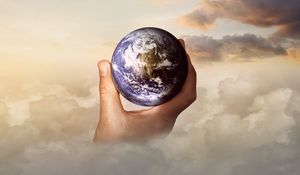 Preview wallpaper globe, hand, photoshop, clouds, world, travel