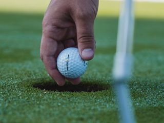 320x240 Wallpaper golf, ball, hand, grass, sport