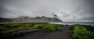 Preview wallpaper grass, coast, sea, mountains, clouds