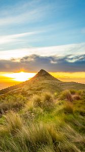 Preview wallpaper grass, mountain, slope, sunset