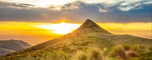 Preview wallpaper grass, mountain, slope, sunset