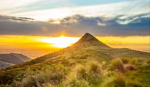 Preview wallpaper grass, mountain, slope, sunset