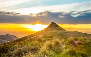 Preview wallpaper grass, mountain, slope, sunset