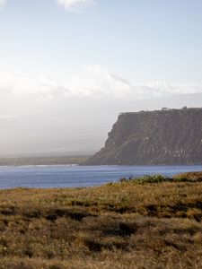 Preview wallpaper grass, sea, slope, mountain, nature, clouds