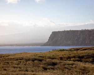 Preview wallpaper grass, sea, slope, mountain, nature, clouds