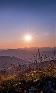 Preview wallpaper grass, stones, mountains, hills, sun, landscape
