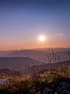 Preview wallpaper grass, stones, mountains, hills, sun, landscape
