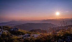 Preview wallpaper grass, stones, mountains, hills, sun, landscape