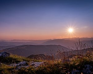 Preview wallpaper grass, stones, mountains, hills, sun, landscape