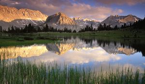 Preview wallpaper grass, water, mountains, sunlight, shade, morning