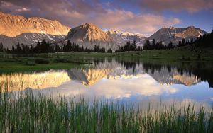 Preview wallpaper grass, water, mountains, sunlight, shade, morning