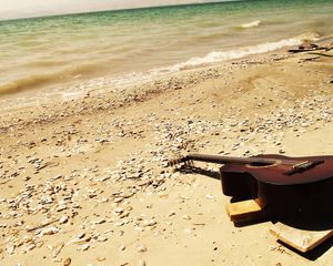 Preview wallpaper guitar, beach, coast, sand, stones, romanticism