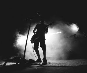 Preview wallpaper guitarist, musician, concert, microphone, performance, smoke, black and white