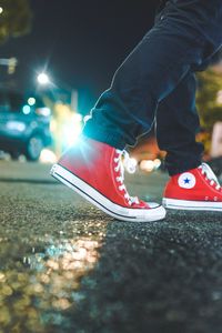 Preview wallpaper gumshoes, legs, asphalt, glare, red