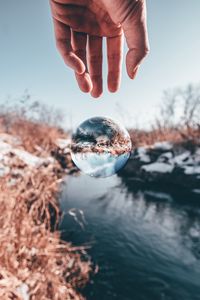 Preview wallpaper hand, ball, glass, transparent, winter, snow