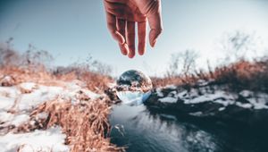 Preview wallpaper hand, ball, glass, transparent, winter, snow