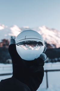 Preview wallpaper hand, ball, glass, mountains, optical illusion